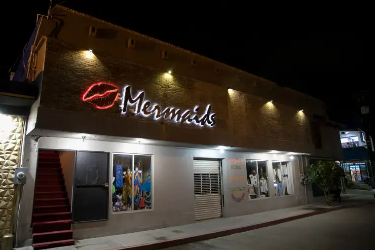 Mermaids storefront lit up at night, Cabo San Lucas